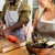 couple cooks together in kitchen